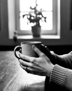 What does it mean to leave a legacy — elderly hands holding a handwritten note representing living legacy, invisible impact, and the quiet meaning of an ordinary life