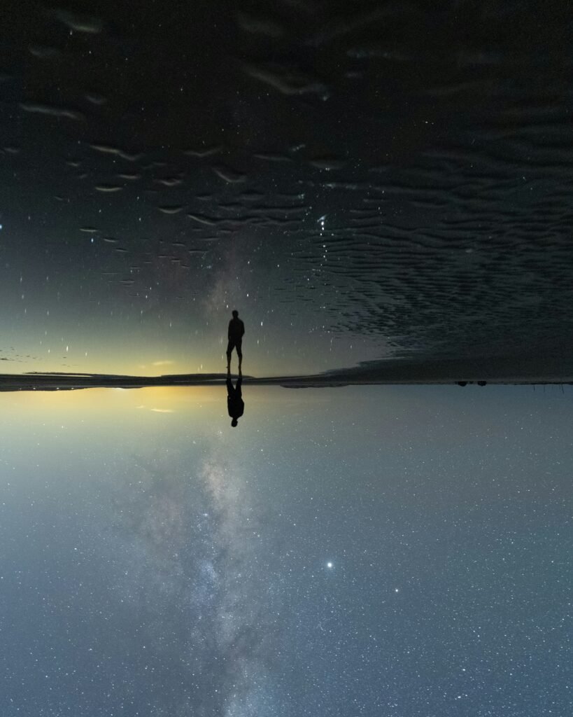 person contemplating cosmic insignificance under a starry night sky