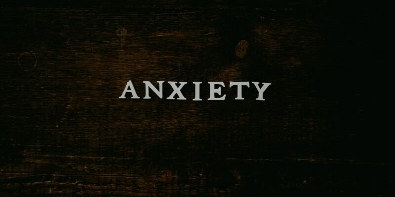 A person feeling trapped by financial limitations despite smartphone technology.