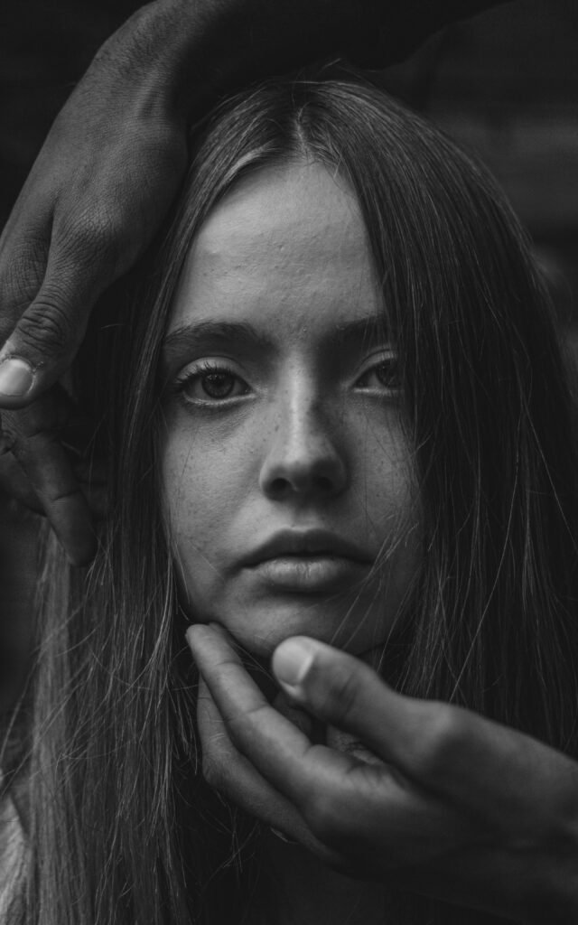 A person expressing emotional pain and internal conflict.