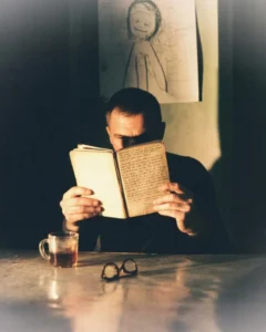 A man reading an old journal late at night — why does nostalgia hurt, being present meaning, lives in the moment