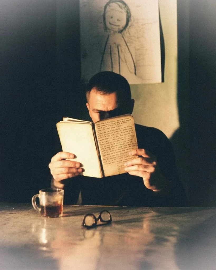 A man reading an old journal late at night — why does nostalgia hurt, being present meaning, lives in the moment